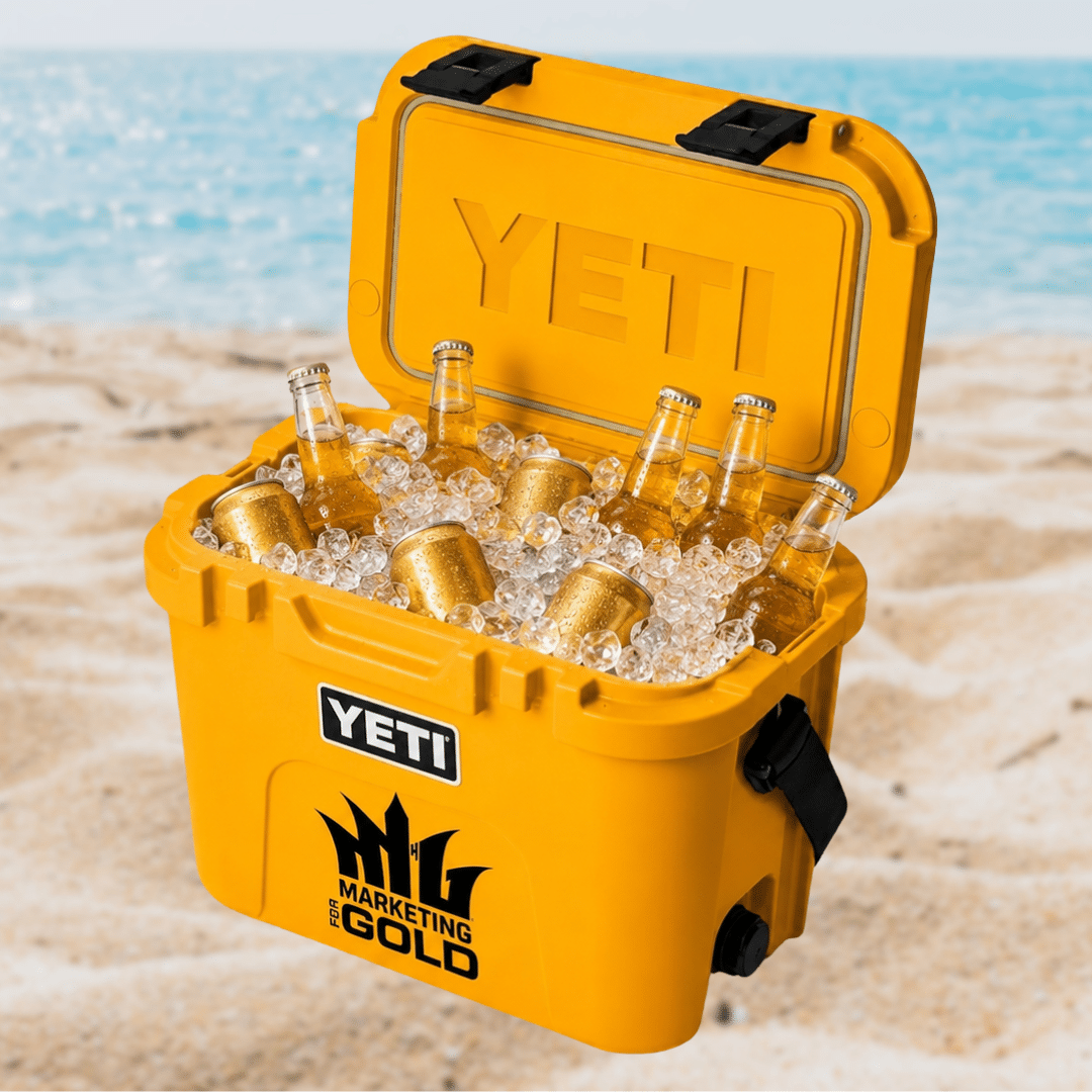 Yellow YETI cooler with Marketing for Gold logo, filled with ice, golden beer bottles, and cans.